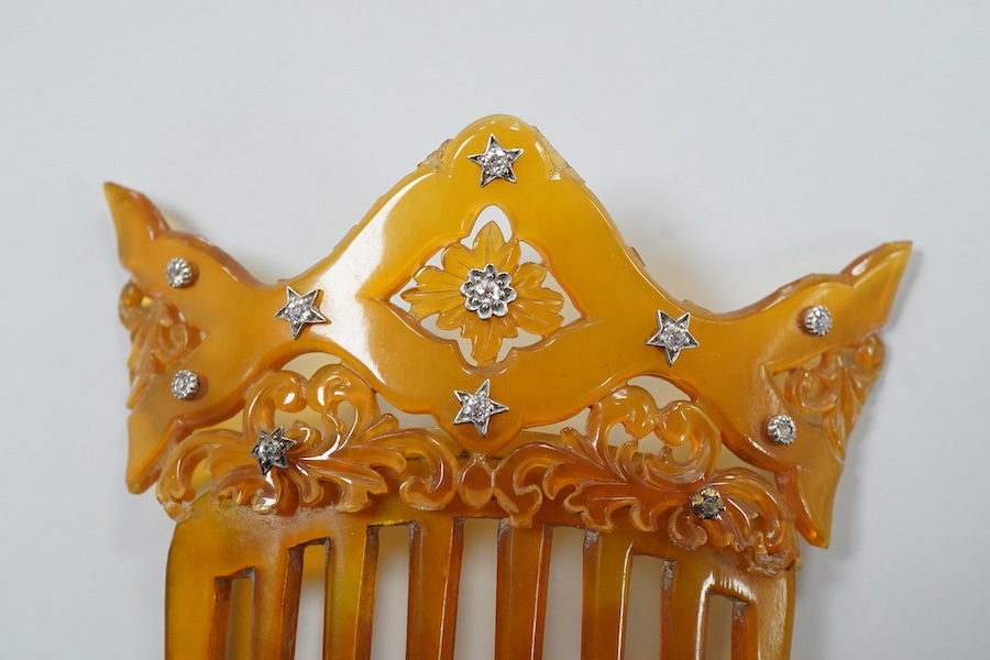 An early 20th century tortoiseshell hair comb set with eleven diamonds, 99mm by 83mm.